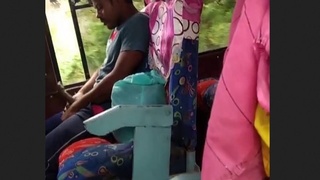 A guy pleasures himself on a bus under the scrutiny of some girls who are recording him