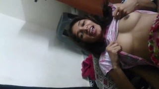 A Tamil woman proudly displays her large breasts in a sensual video