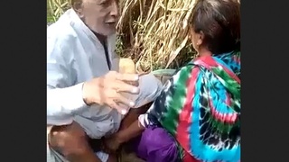 Elderly man Tau engages in sexual activity with Randi amidst the wilderness