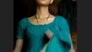 A youthful woman undresses and playfully entices in a rural setting