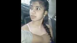 A South Asian college girl gives her lover a blowjob in a car