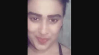 A seductive girl displays her adorable breasts alone