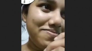 This video features a beautiful woman proudly displaying her large breasts