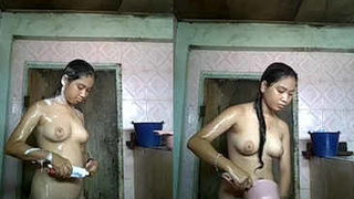 An Indonesian beauty washes and pleasures herself in the shower