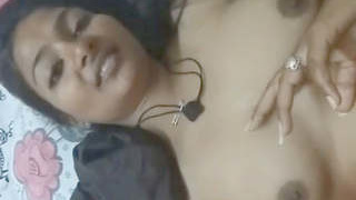 A seductive woman pleasures herself while her partner has sex with her