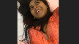 Indian girl pleasures herself while speaking and sucking her fingers