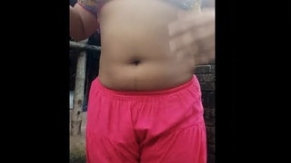 A seductive dark-haired woman enjoys a bath and self-pleasure