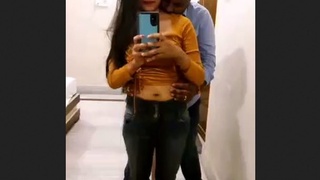 A loving couple explores each other's bodies in front of a hotel mirror