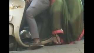 Wife pleasuring husband's penis on scooter