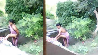 Indian girl takes outdoor bath
