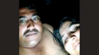 A mature couple shares a romantic evening in the countryside