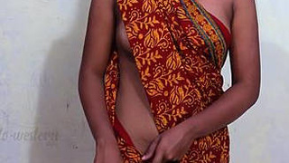 Slim middle-aged woman in a sari without a bra reveals her alluring bosom and belly button