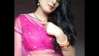 Heena Kumari, a charming housewife, reveals her navel in a sheer saree.